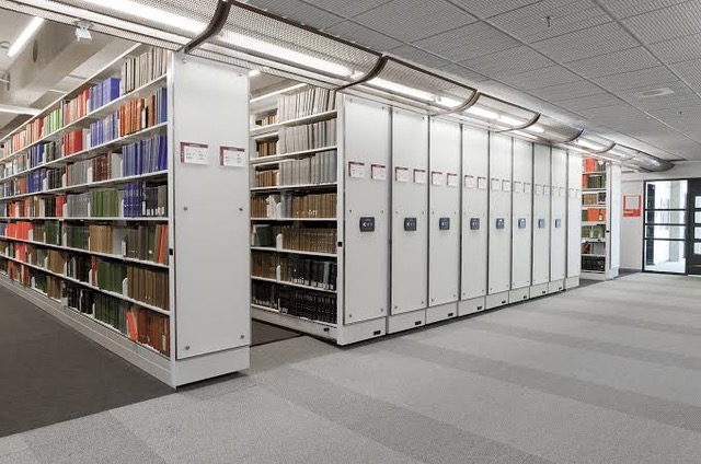 SafeAisle powered mobile storage system in a library setting with multiple carriages in a long row